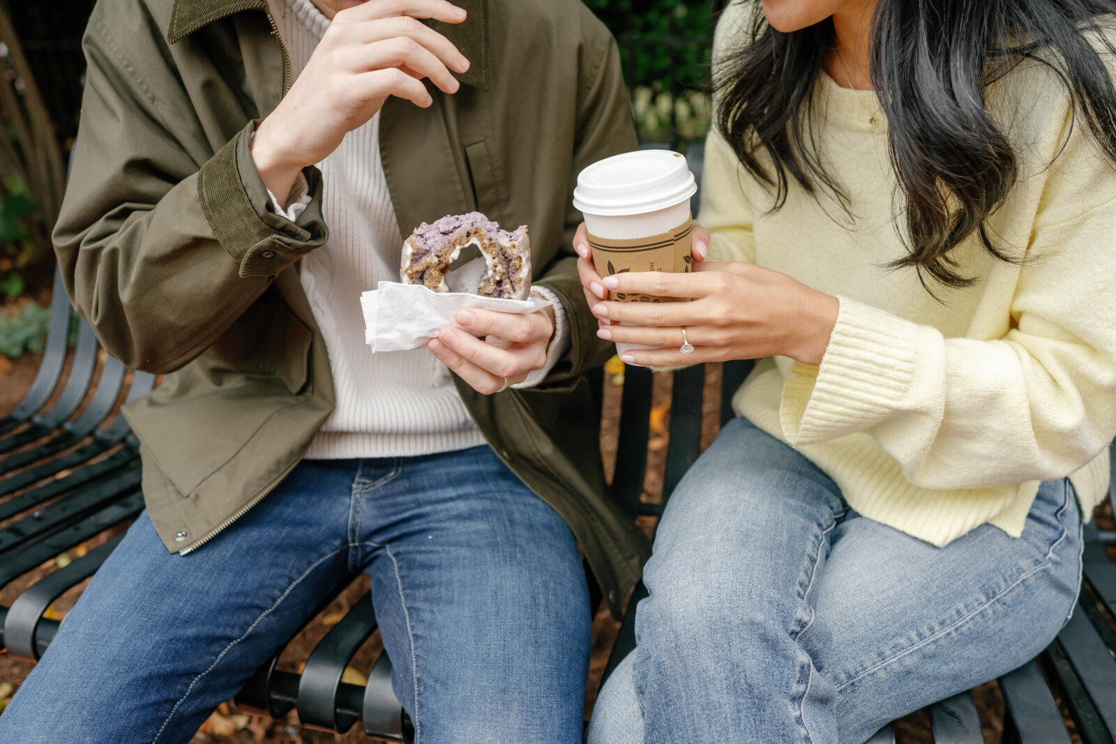 Couple holding coffee and pastry during Eastern Market Washington DC engagement session