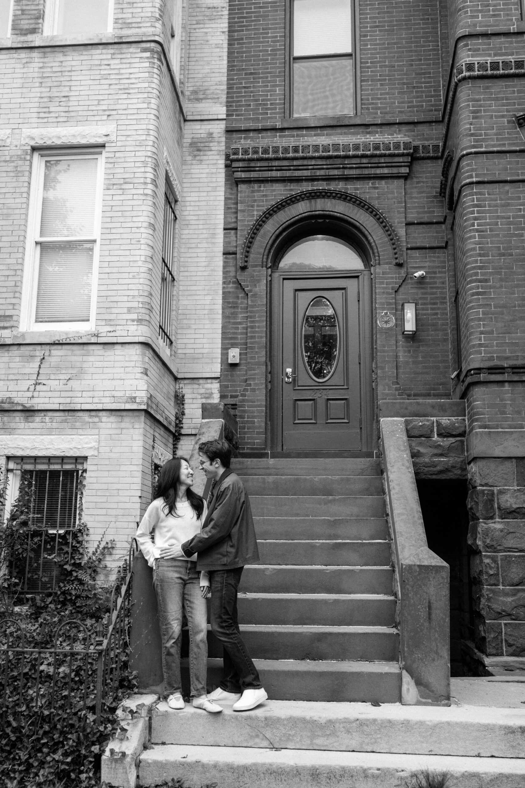 Couple standing on historic row house steps during Capitol Hill engagement session in Washington DC