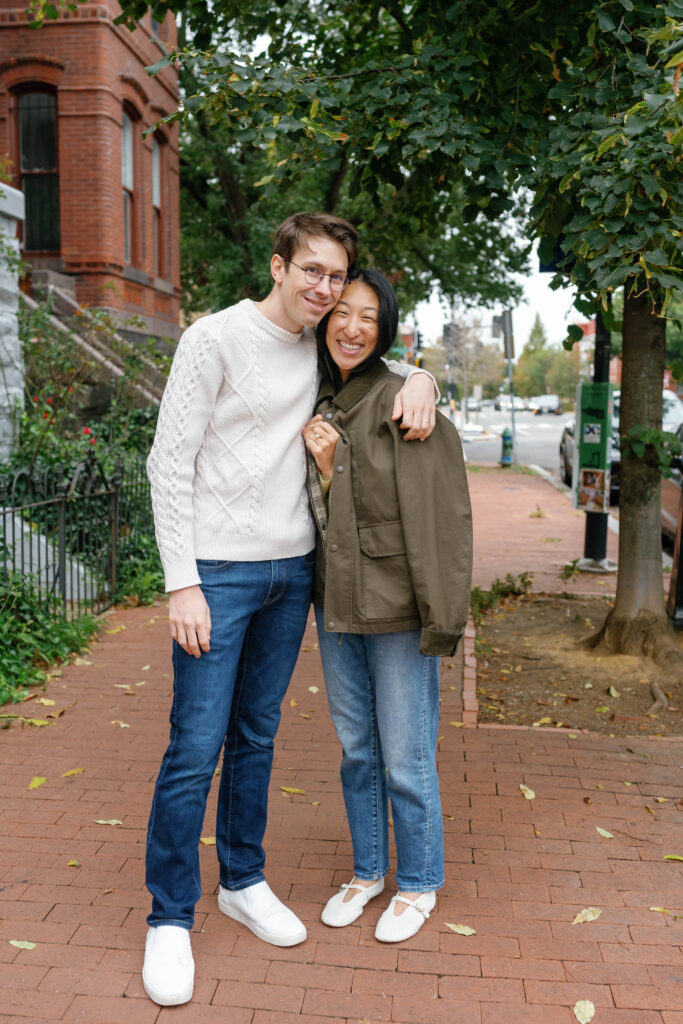 Couple standing together on brick sidewalk during Capitol Hill Washington DC engagement session