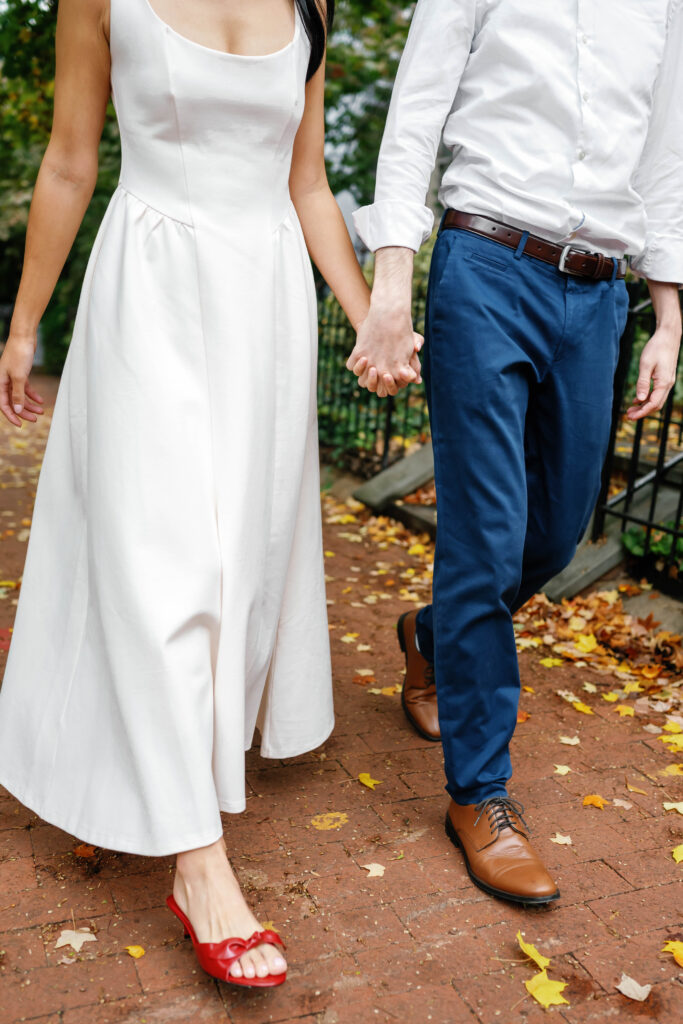 Close up of couple holding hands while walking through Capitol Hill during Washington DC engagement session