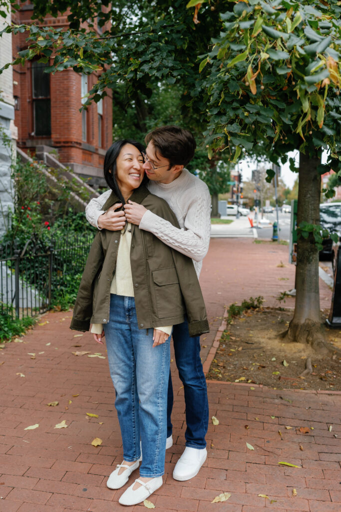 Couple walking together under trees during Capitol Hill Washington DC engagement session