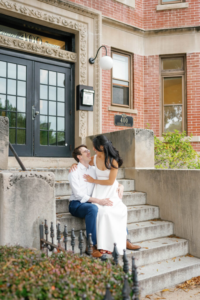 Couple sitting together on historic Capitol Hill row house steps during Washington DC engagement session
