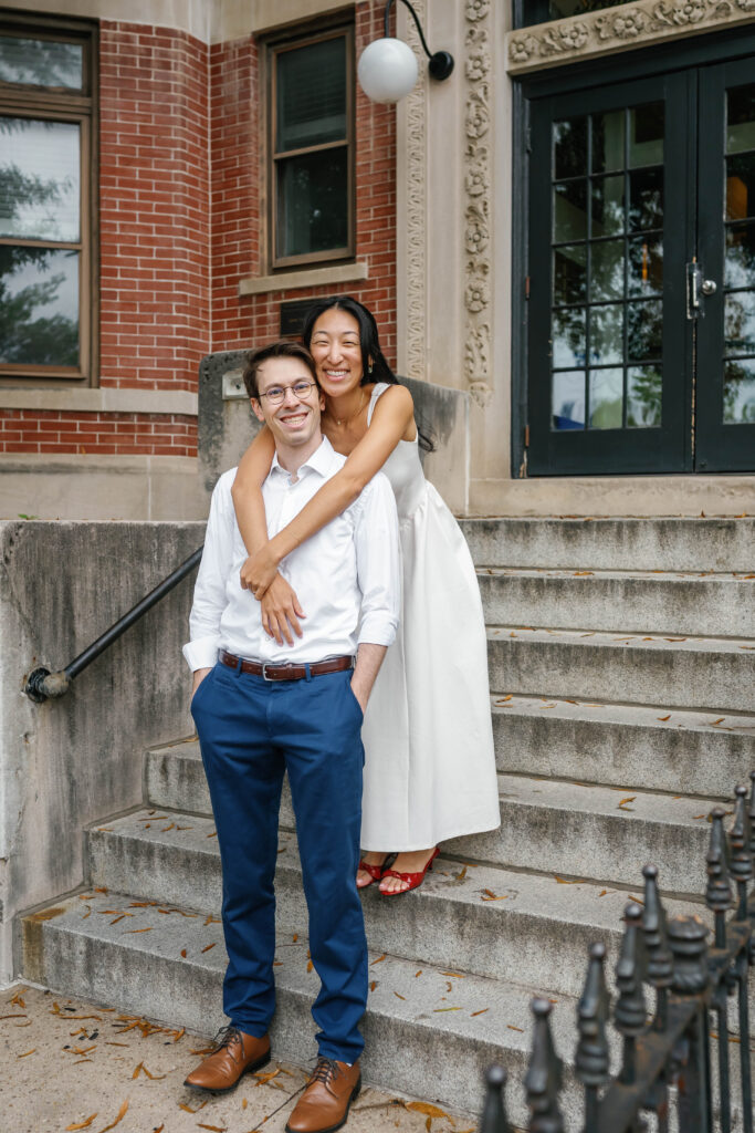 Couple smiling together on historic Capitol Hill row house steps during Washington DC engagement session
