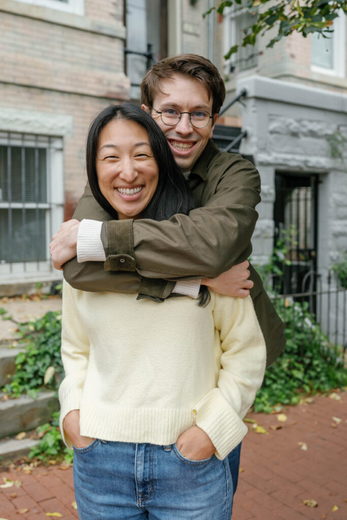 Couple smiling together on historic Capitol Hill row house steps during Washington DC engagement session