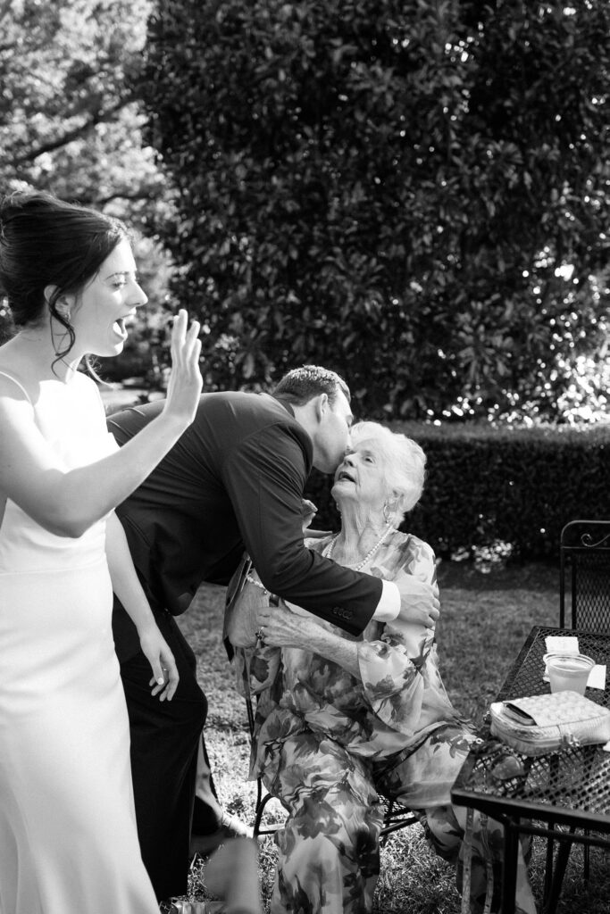 Bride greeting and celebrating with family members during cocktail hour at Appleford Estate surrounded by guests and loved ones.