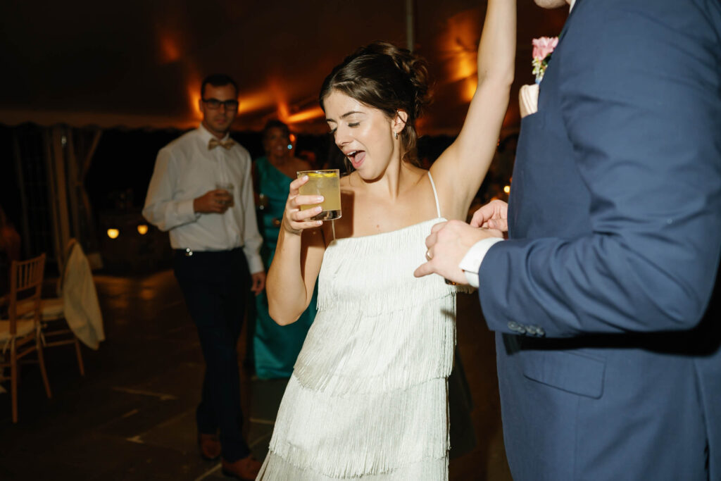 Joyful dance floor moment during the Appleford Estate wedding reception as the bride celebrates with guests late into the evening.