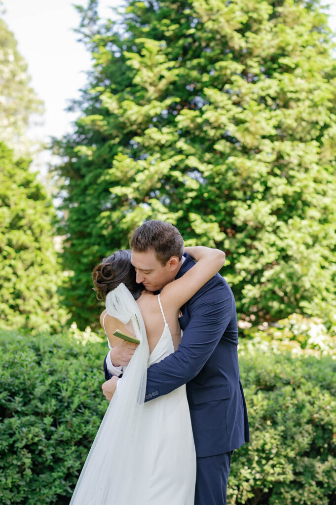 bride and groom embrace during first look at appleford estate